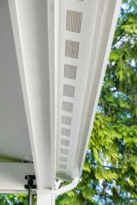 White roof soffit with a long, linear vent strip installed along the eaves.