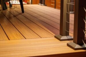 Wooden deck with a metal cable railing system.