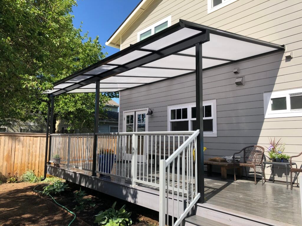 An Acrylite patio cover protects this Portland area deck from the winter rain