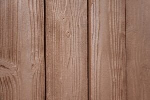 Close-up of vertical brown wooden planks with visible grain texture.