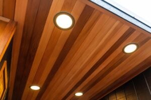 Four recessed lights set into a paneled wood ceiling.