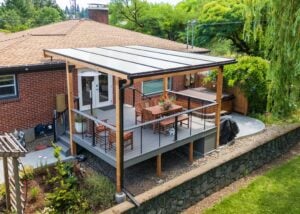Raised backyard deck with a translucent patio cover, a wooden dining set, and a hot tub.