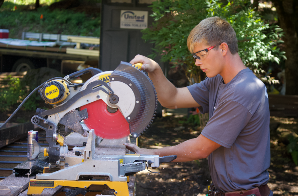 Worker using a table saw