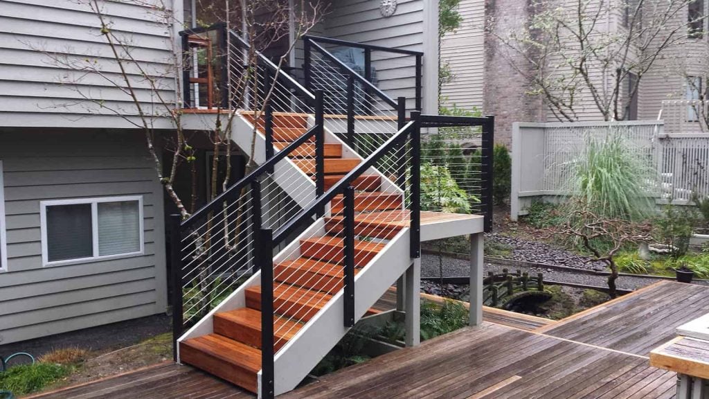 Black aluminum cable railing on wood stairs