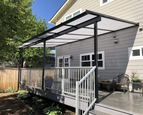 An Acrylite patio cover protects this Portland area deck from the winter rain