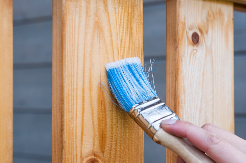 Picture of staining a cedar fence